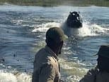 Astonishing moment a hippo chases tourists through the water and keeps up with their speeding boat