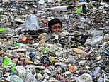 The river of garbage: Workers wade through rubbish after storm hits the Philippines