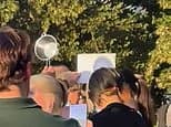 Moment man uses colander at packed London park to watch the eclipse... and he's not alone