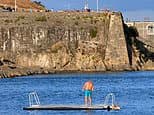 Moment reckless 'tombstoning' youths leap off 65ft cliff and into water at notorious Dead Man's Cove