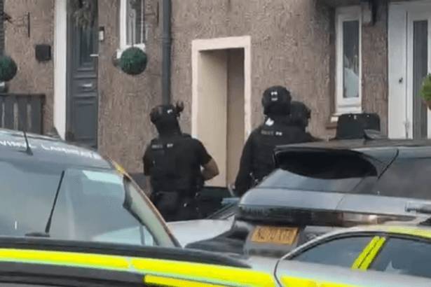 Armed police swoop on Ayrshire home amid ongoing incident as street sealed off