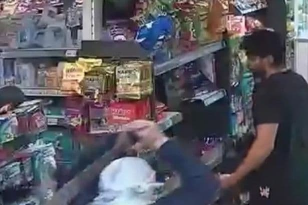Masked machete thug attempts to rob shop and demands cash in shocking footage