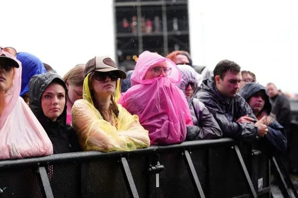 Reading Festival fans brave torrential rain and mud bogs as Britain faces horror thunderstorms this weekend