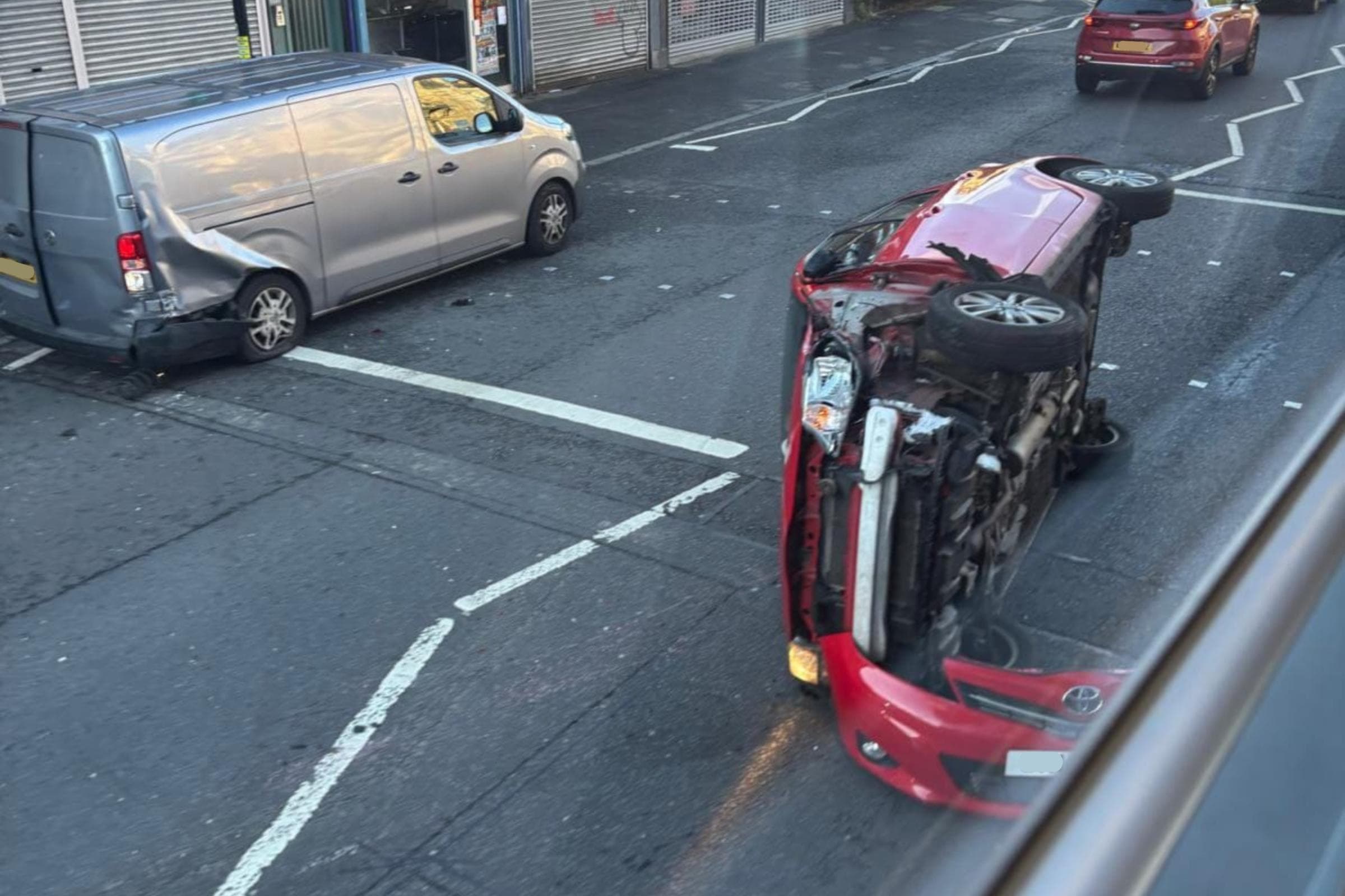 Rush hour delays in Glasgow as horror crash flips car on its side