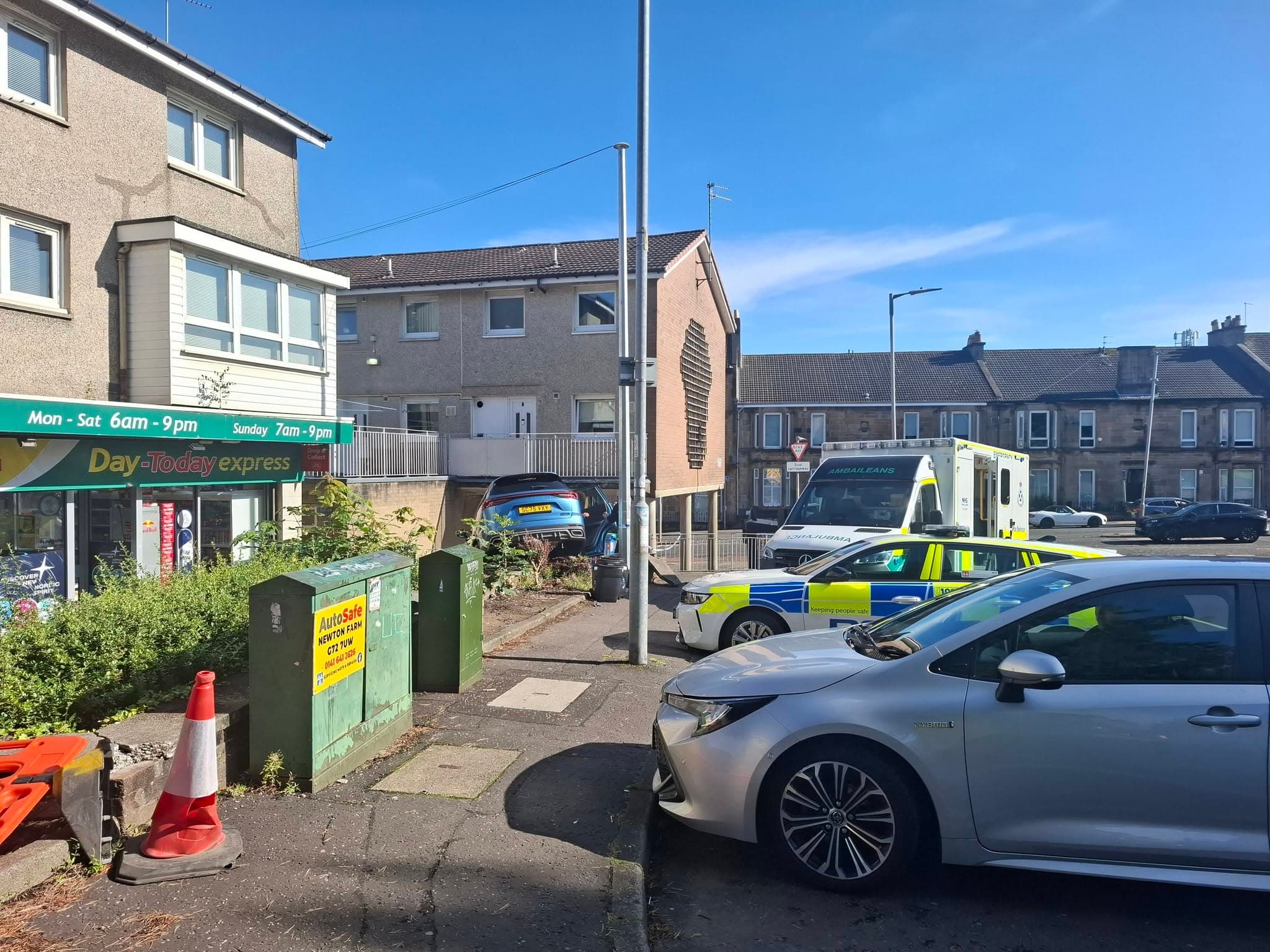 Emergency services rush to scene of severe crash outside row of shops