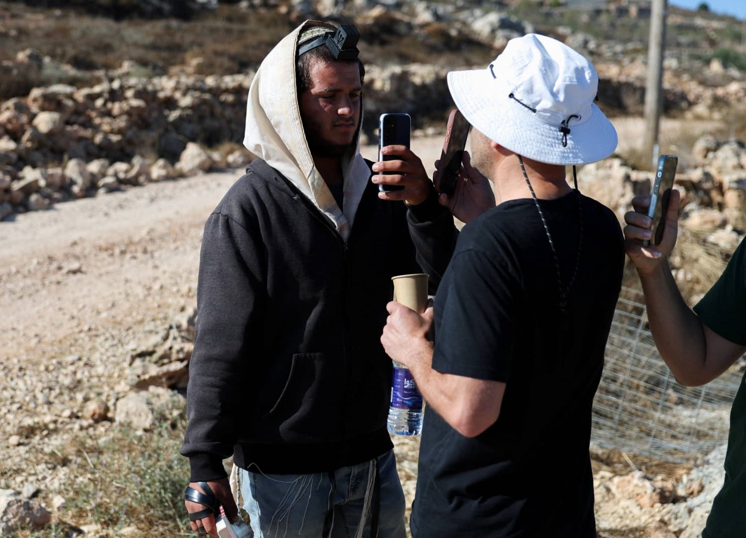 Israeli settler confronts Palestinian American at his besieged West Bank home
