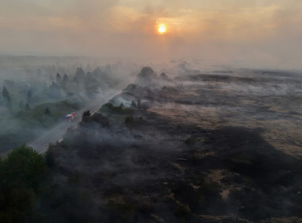 Firefighters battle massive wildfires in Belgium and Greece as 2 die on an island near Athens