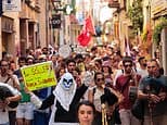 Thousands of anti-tourism protesters take to the streets of Majorca, with some waving anti-English banners