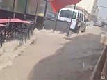 Moment freak thunderstorm batters Spain - seeing tourists run for cover as streets turn to rivers