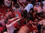 Paint the town red! Thousands take over Spanish village for the La Tomatina food fight