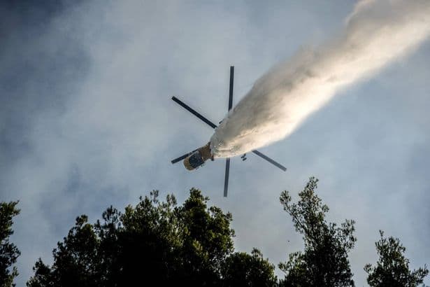 Two helicopters crash mid-air while tackling wildfires in Greece as more than 100 homes destroyed
