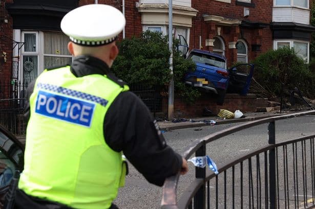 Unconscious person taken to hospital after car smashes into house on busy North East road