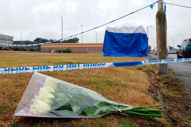 Flowers left at industrial estate after girl, 9, dies as shocked workers arrive to crime scene