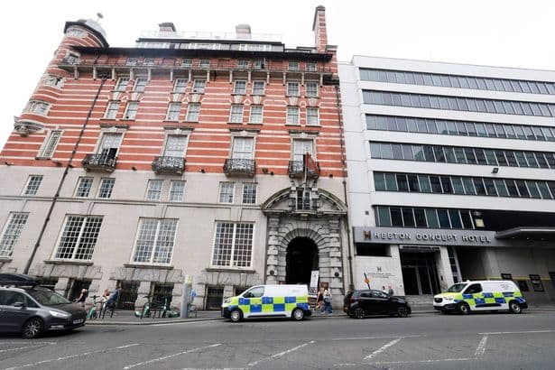 Woman found dead at UK hotel 'after falling ill' as two arrested on suspicion of murder
