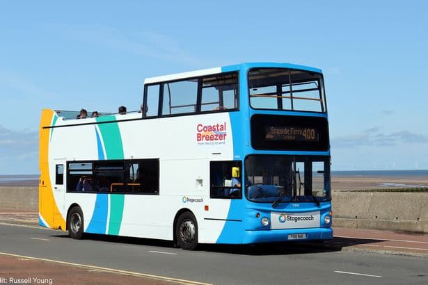 Open top bus taking passengers to seaside town back for summer in Merseyside