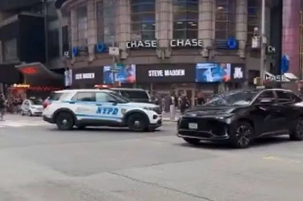 Woman shot by police in Times Square after two stabbed in robbery