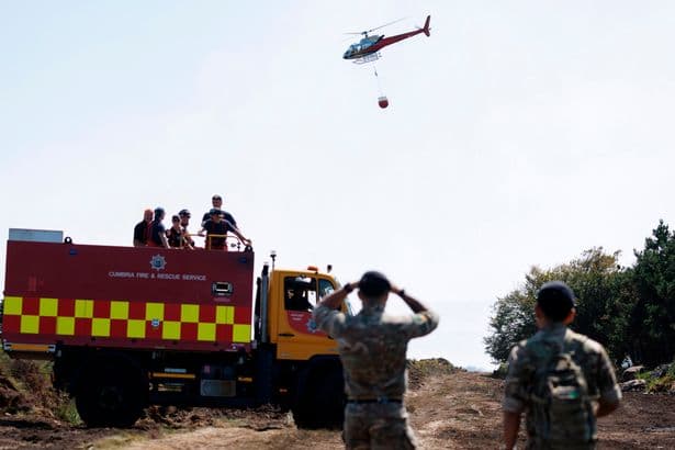 Three teenagers arrested for arson as fire crews and 200 soldiers battle on