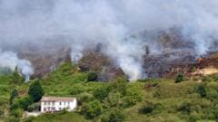 Fires started 'deliberately' on mountain as crews tackle blaze
