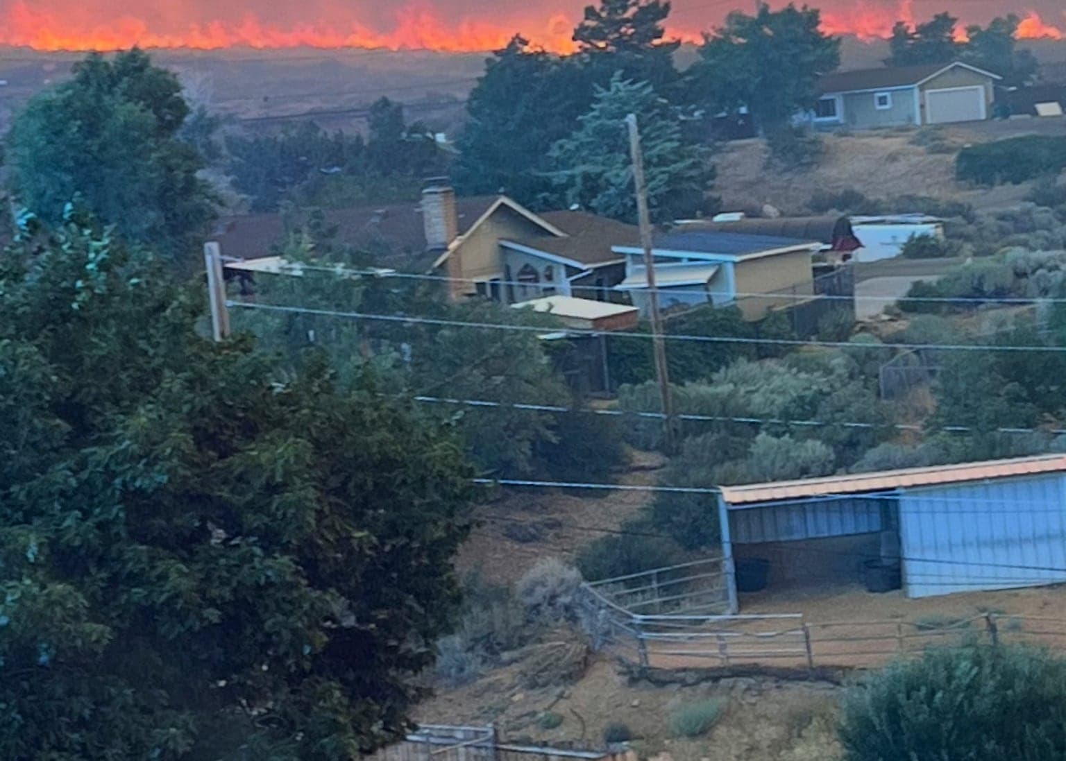 Firefighters trying to stop fast-moving Nevada wildfire from spreading to Reno