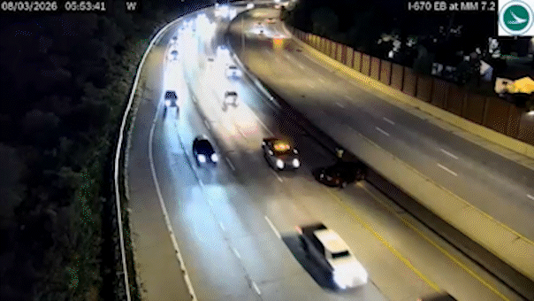 Vehicle narrowly avoids slamming into driver on side of Ohio highway, dramatic video shows