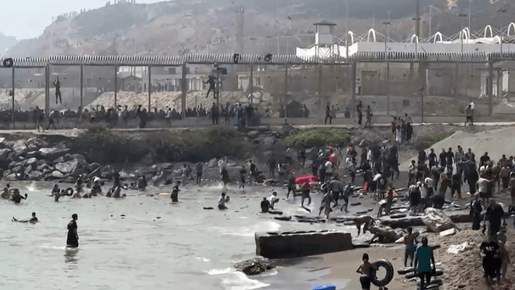 Hundreds of migrants swim from Morocco to Spanish enclave of Ceuta